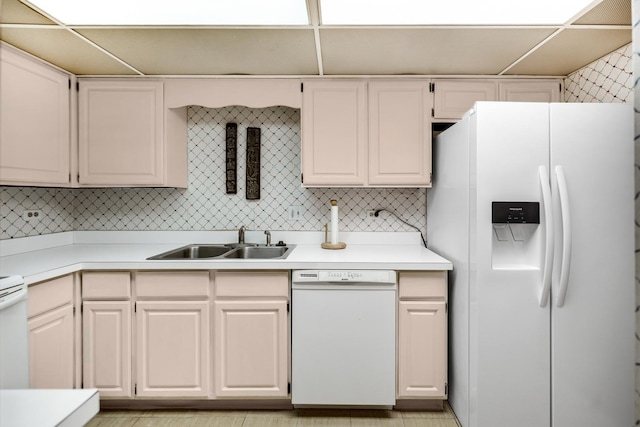 kitchen featuring tasteful backsplash, sink, white cabinets, and white appliances