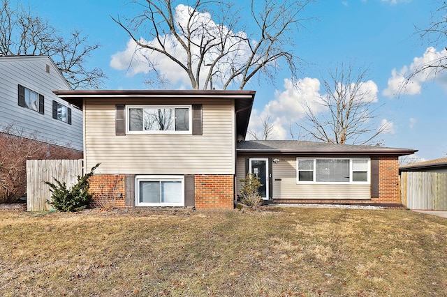 tri-level home with a front lawn