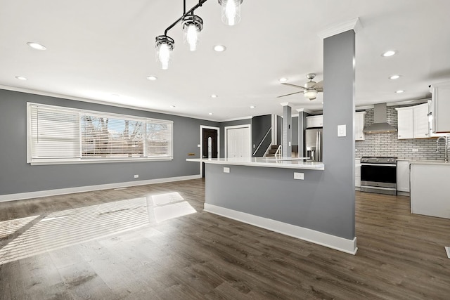 kitchen featuring wall chimney exhaust hood, appliances with stainless steel finishes, dark hardwood / wood-style flooring, white cabinets, and backsplash