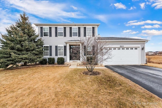 view of front of home featuring a garage and a front lawn