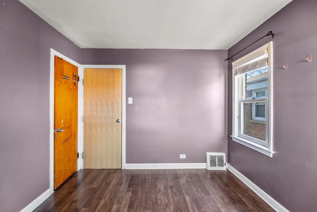 empty room featuring dark hardwood / wood-style flooring