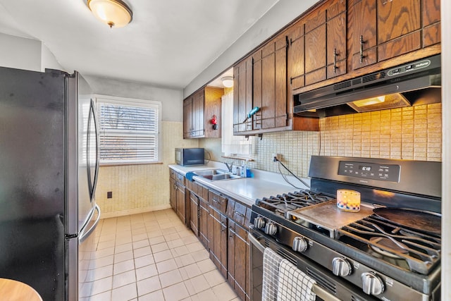 kitchen featuring appliances with stainless steel finishes, sink, and light tile patterned floors