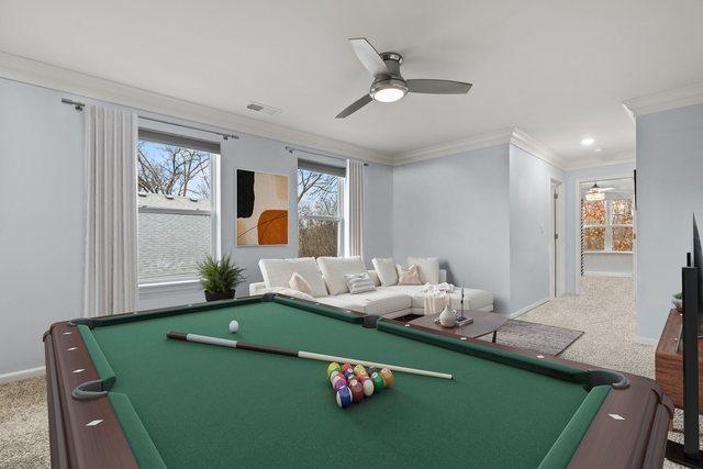 rec room with carpet, ornamental molding, and ceiling fan