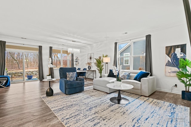 living room featuring hardwood / wood-style flooring and an inviting chandelier