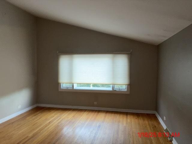 unfurnished room with lofted ceiling and light hardwood / wood-style flooring