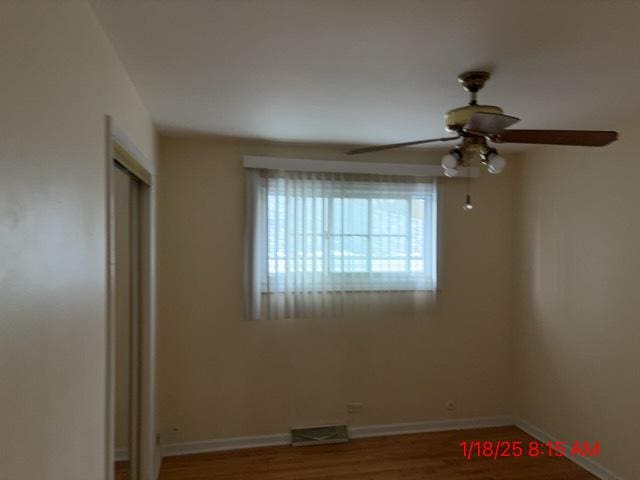 empty room featuring ceiling fan and hardwood / wood-style floors