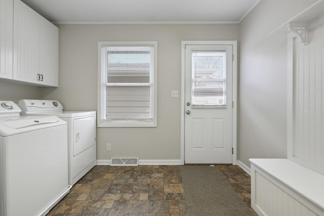 laundry room featuring washer and clothes dryer, ornamental molding, and cabinets