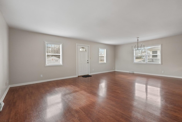 foyer featuring dark hardwood / wood-style flooring and a notable chandelier