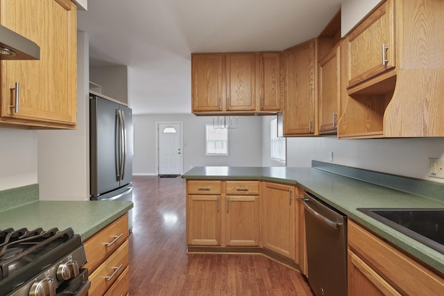 kitchen featuring ventilation hood, dishwasher, dark hardwood / wood-style floors, and kitchen peninsula