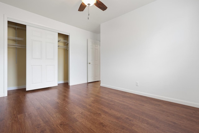 unfurnished bedroom featuring dark hardwood / wood-style flooring, a closet, and ceiling fan