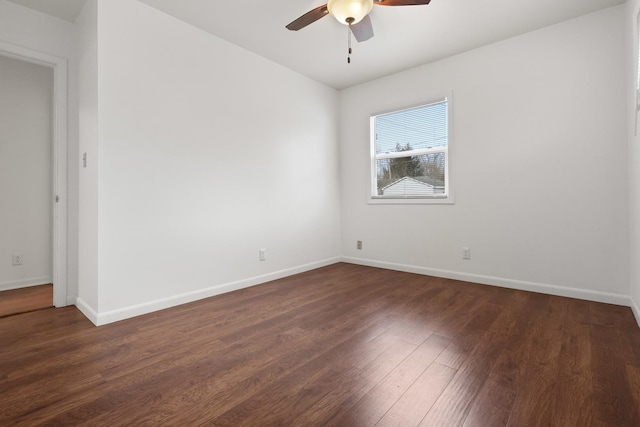 spare room featuring dark hardwood / wood-style floors and ceiling fan