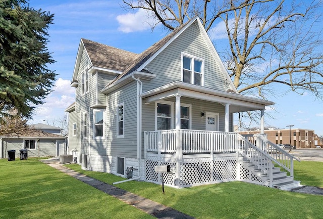 view of front of home featuring central AC, a porch, and a front yard