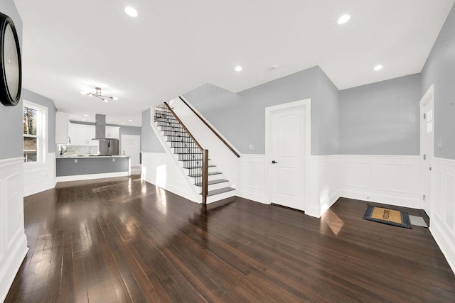 unfurnished living room with dark hardwood / wood-style floors