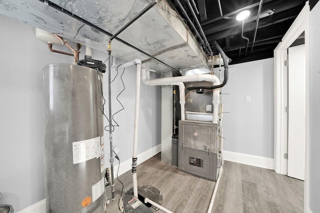 utility room with heating unit and gas water heater