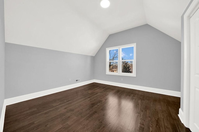 bonus room featuring lofted ceiling and dark hardwood / wood-style floors