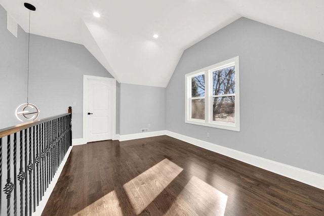 bonus room with hardwood / wood-style flooring and vaulted ceiling