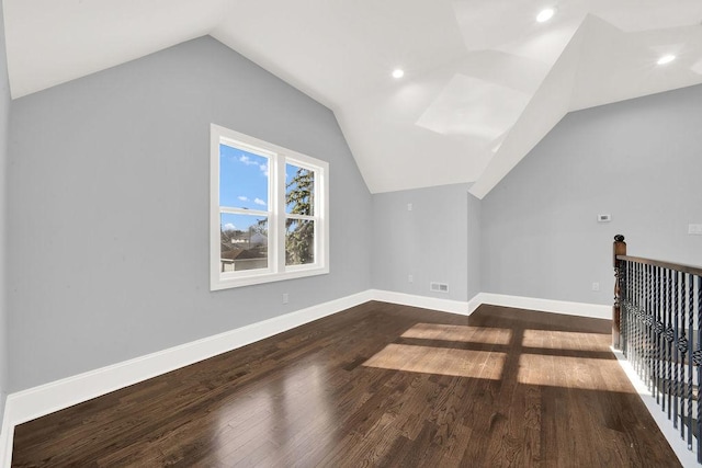 bonus room featuring vaulted ceiling and dark wood-type flooring