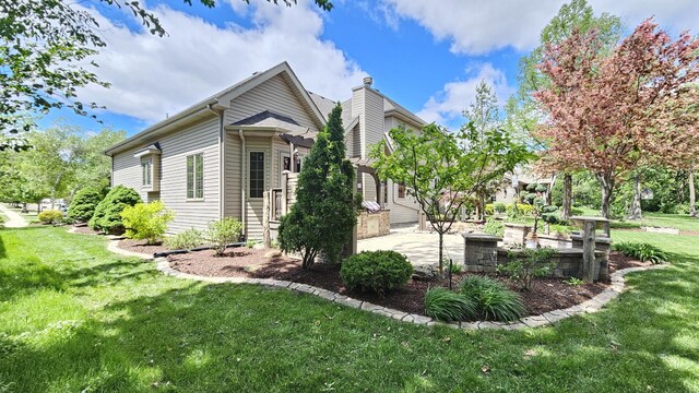 26357 S Lyndsay Dr, Channahon, IL 60410 - view of side of home with a patio, a yard, and a chimney