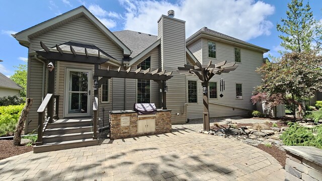 26357 S Lyndsay Dr, Channahon, IL 60410 - rear view of house featuring a pergola, exterior kitchen, a chimney, and a patio area