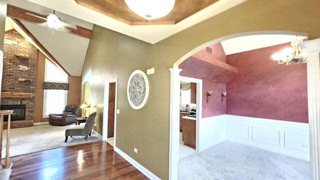 26357 S Lyndsay Dr, Channahon, IL 60410 - corridor featuring arched walkways, high vaulted ceiling, wood finished floors, a chandelier, and a wainscoted wall
