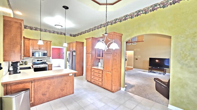 26357 S Lyndsay Dr, Channahon, IL 60410 - kitchen featuring appliances with stainless steel finishes, arched walkways, open floor plan, light countertops, and a sink