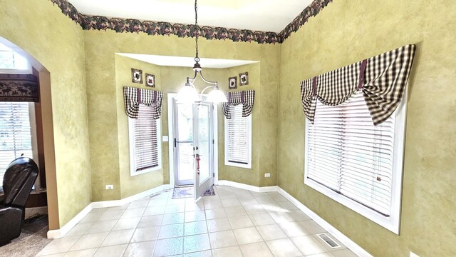 26357 S Lyndsay Dr, Channahon, IL 60410 - entrance foyer with arched walkways, a chandelier, tile patterned flooring, and baseboards