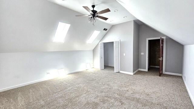 26357 S Lyndsay Dr, Channahon, IL 60410 - additional living space featuring lofted ceiling, a ceiling fan, light colored carpet, a skylight, and baseboards