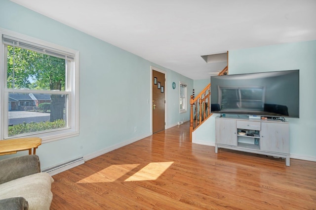 living room featuring a baseboard radiator and light wood-type flooring