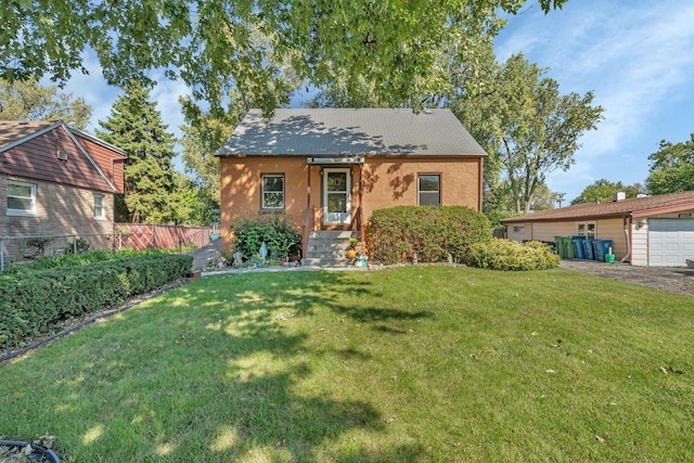 view of front of house featuring a garage and a front lawn