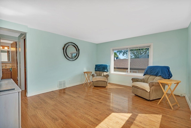 living area with light hardwood / wood-style floors