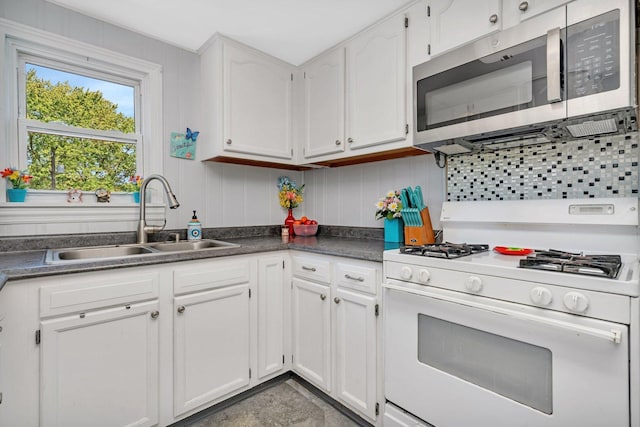 kitchen with sink, white cabinets, and white gas stove