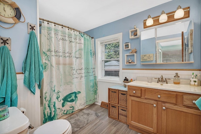 full bathroom featuring vanity, hardwood / wood-style flooring, toilet, and shower / bath combo with shower curtain