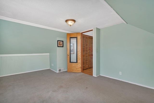 spare room with carpet and a textured ceiling