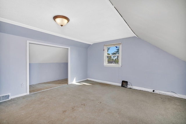 bonus room featuring vaulted ceiling and carpet floors