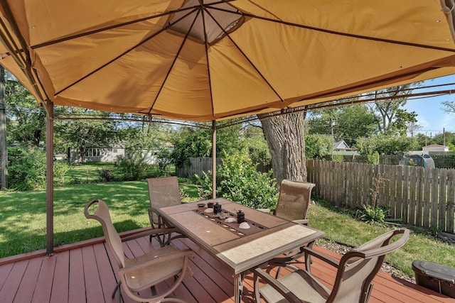 wooden terrace featuring a gazebo and a lawn