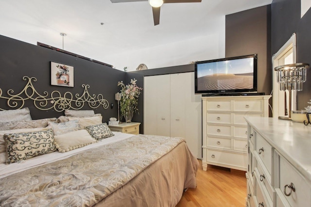 bedroom with a closet, ceiling fan, and light wood-type flooring