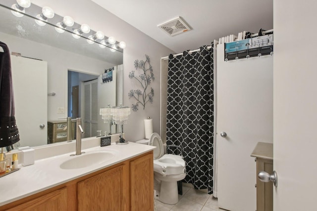 bathroom with tile patterned flooring, vanity, walk in shower, and toilet