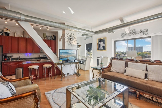 living room with sink and light hardwood / wood-style floors