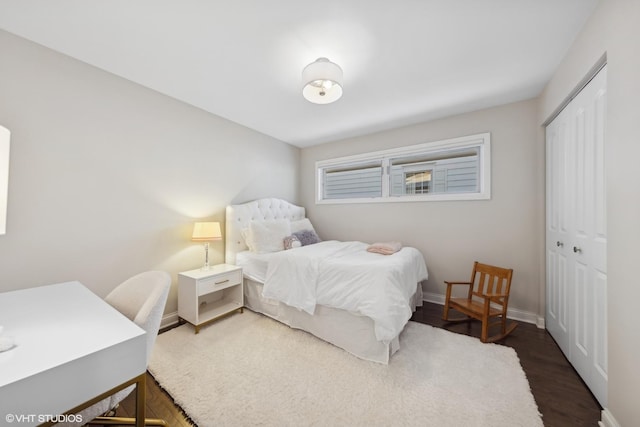 bedroom featuring dark hardwood / wood-style flooring and a closet