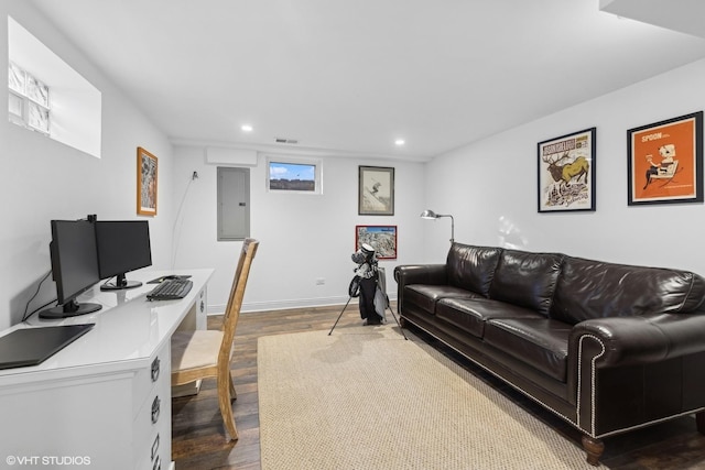 office with dark hardwood / wood-style flooring and electric panel