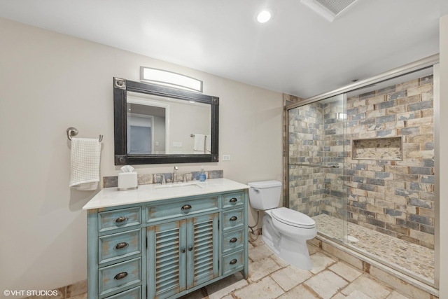 bathroom with vanity, walk in shower, and toilet