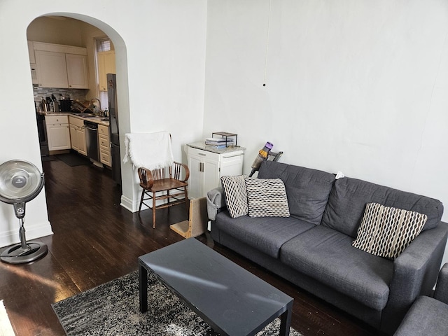 living room with sink and dark wood-type flooring