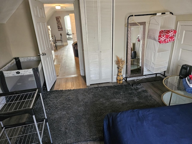 bedroom with hardwood / wood-style floors and a closet