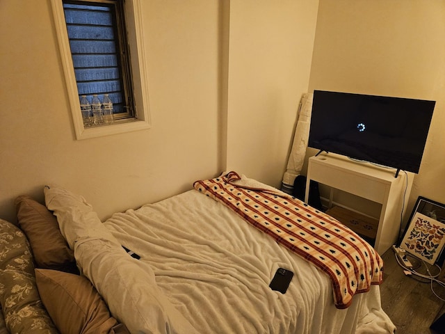 bedroom with hardwood / wood-style flooring