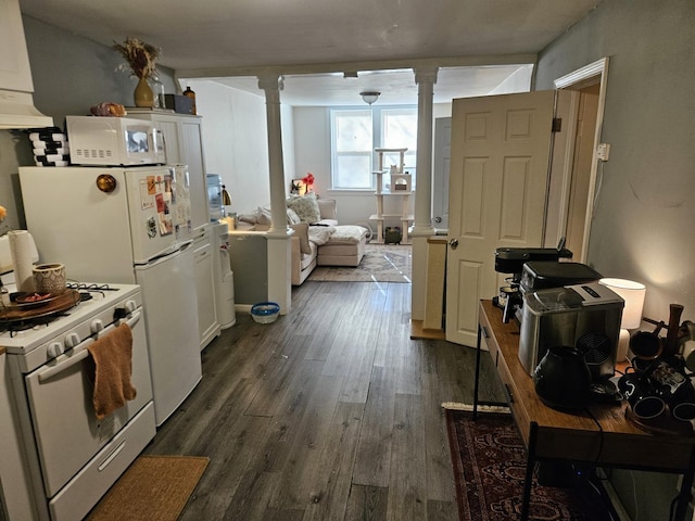 kitchen with dark wood-type flooring, white appliances, white cabinetry, and decorative columns