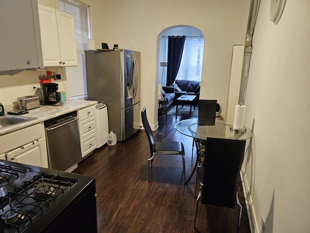 kitchen featuring stainless steel appliances, dark hardwood / wood-style floors, sink, and white cabinets