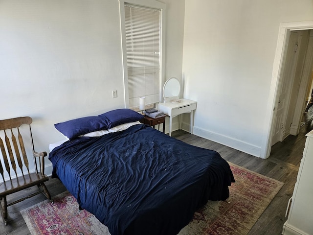 bedroom with dark hardwood / wood-style floors