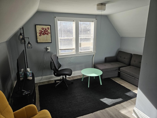 interior space featuring lofted ceiling and light hardwood / wood-style floors