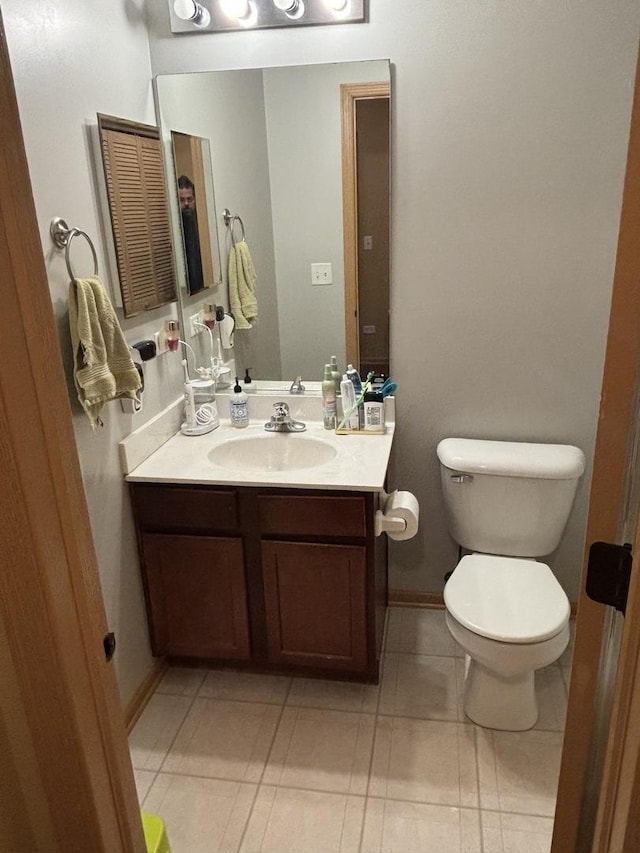 bathroom with tile patterned flooring, vanity, and toilet