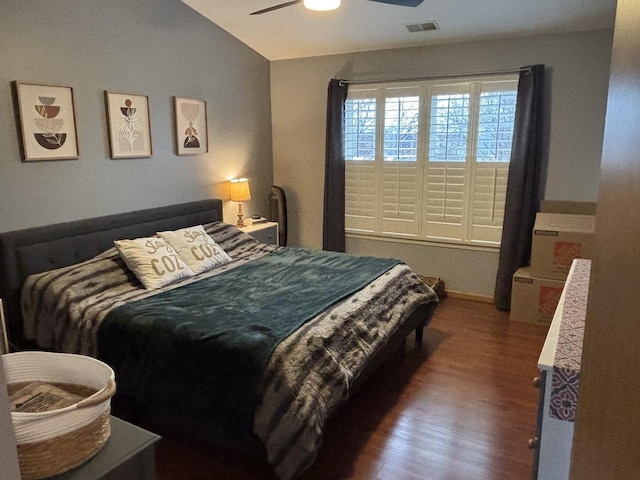 bedroom with ceiling fan, dark hardwood / wood-style floors, and vaulted ceiling